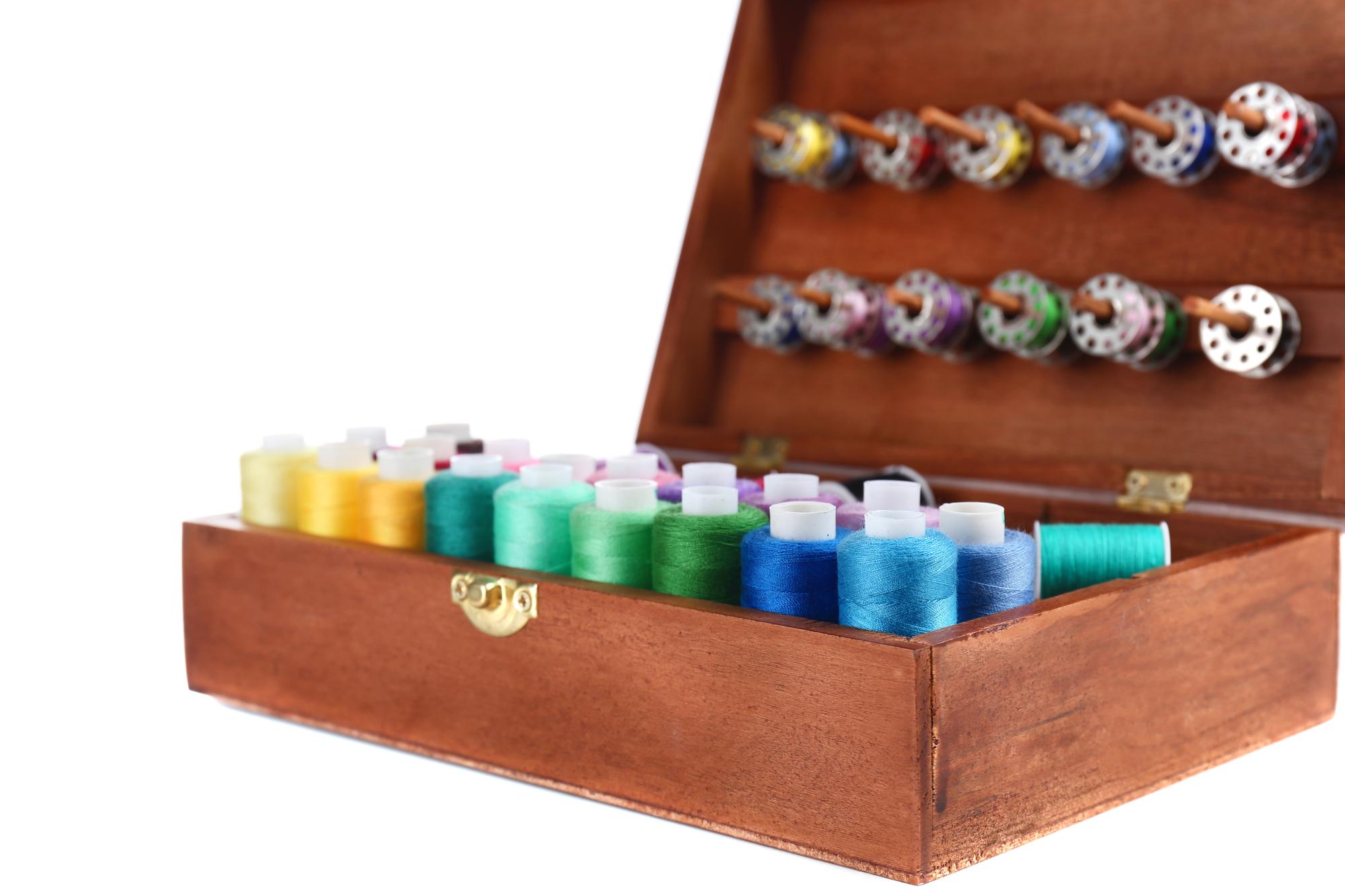 maker unboxing an embroidery kit at a wooden table